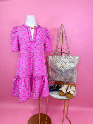 Pink v-neck mini dress with pink and green floral details 