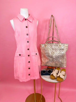 Pink sleeveless dress on a woman with collar and button-down detailing