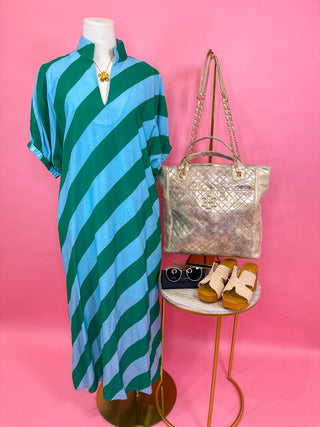 Woman wearing a green and blue striped dress with v-neck