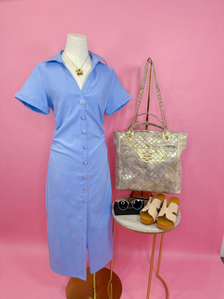 Short sleeve baby blue midi dress with a collared neckline, button front with ring detail buttons, subtle ruching, and a front slit 